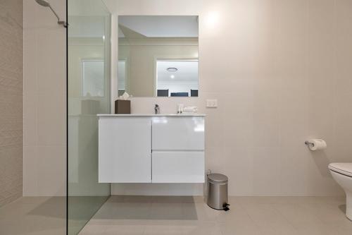 a bathroom with a sink and a toilet at CH Boutique Apartments The Ringers Road in Tamworth