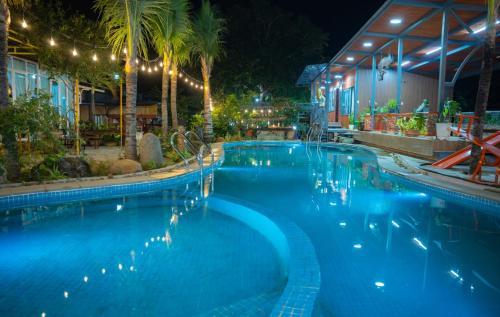 ein großer Swimmingpool in der Nacht mit Lichtern in der Unterkunft Boss cà phê & Homestay in Chi Lăng
