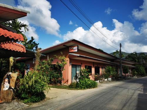 a building on the side of a street at Subsavet Village in Baan Tai