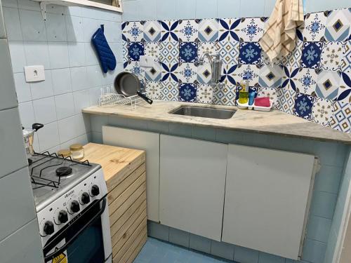 a kitchen with a sink and a stove at Rua da Aurora in Recife