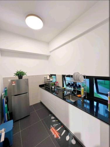 a kitchen with a sink and a counter top at Duplex Town House at EcoBotanic Near Legoland with Netflix and KTV System in Nusajaya