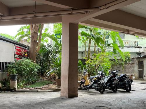 two motorcycles parked next to each other under a building at We Residence Studio in Pattaya Central