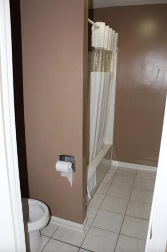 a bathroom with a toilet and a shower at economy inn augusta in Augusta