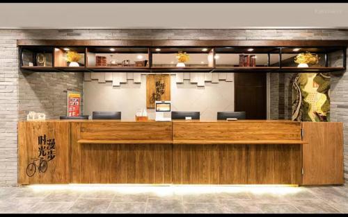 a restaurant with a large wooden reception desk at Nost algia Hotel Near University of Technology -Shanxi museum 时光漫步酒店 太原理工大学下元店 Free fresh ground coffee,Free laundry service in Taiyuan