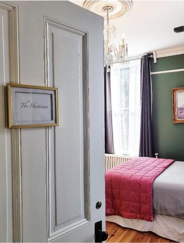 a bedroom with a bed with a red blanket at South Court Inn in Luray