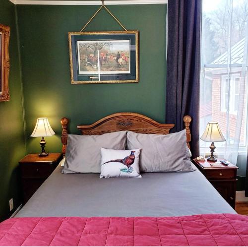 a bedroom with a large bed with two pillows at South Court Inn in Luray