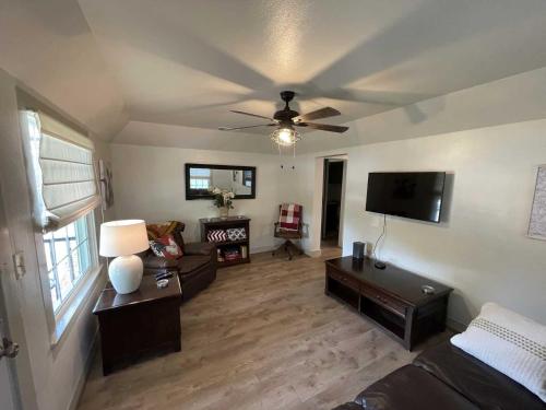 a living room with a couch and a ceiling fan at Cherry Street Star in Bandera
