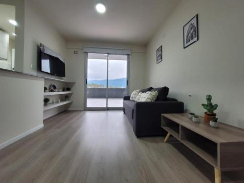 a living room with a couch and a table at ML NORTE Departamento in San Salvador de Jujuy