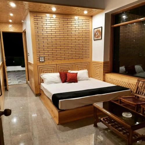 a bedroom with a bed and a large window at The MoonLight Stay - Shimla in Shimla