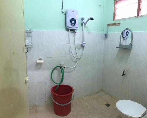 a bathroom with a toilet and a bucket at Ruhani Homestay 2 Kota Bharu Cheap and Comfortable in Kota Bharu