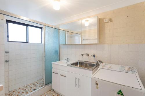 a small bathroom with a sink and a shower at Apollo Unit 20 Ground Floor in Narooma