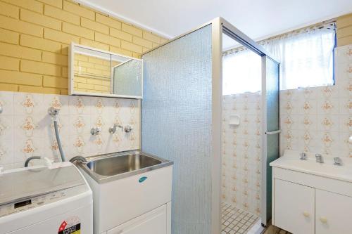 a small bathroom with a sink and a shower at Apollo Unit 27 - Ground Floor - C Block in Narooma