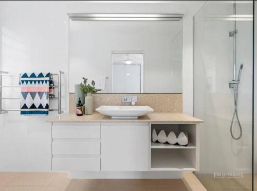 a white bathroom with a sink and a shower at Sunshine Beach Gem in Sunshine Beach