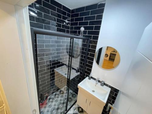 a small bathroom with a sink and a mirror at Private Apt, 2 mins to Transp. in Istanbul