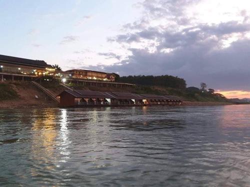 a train station on the shore of a body of water at Riverside Chiangkhan in Ban Mai Ta Saeng