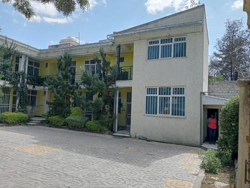 a woman standing in the doorway of a building at Avi Guest House in Addis Ababa