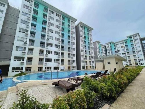 a large apartment building with a large swimming pool at Davao City Condo Living Made Easy Lifestyle in Davao City