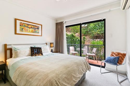 a bedroom with a large bed and a balcony at Perth City Retreat - free parking in Perth