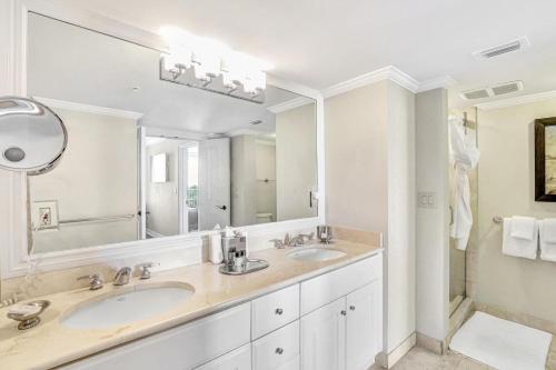 a bathroom with two sinks and a large mirror at Marco Beach Ocean Resort Unit 905 in Marco Island