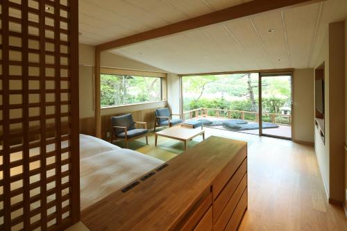 a bedroom with a large bed and a large window at Monjusou in Miyazu