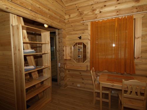 a dining room with a table in a log cabin at Nelijärve Holiday Centre in Aegviidu