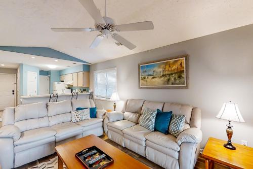 a living room with two white couches and a ceiling fan at Pinehurst X-7 in Little River