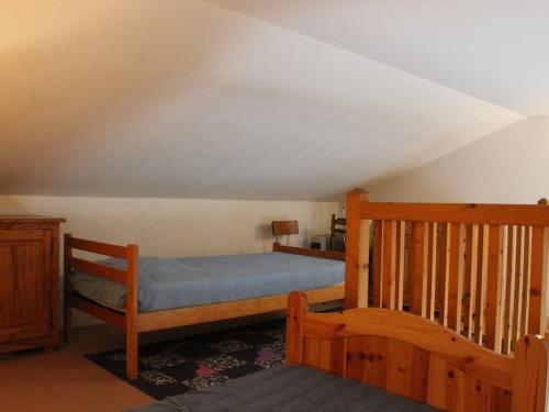 - une chambre avec un lit et un escalier en bois dans l'établissement Appartement 5 pers, près plage, balcon, parking, La Cotinière - FR-1-246A-89, à Saint-Pierre-dʼOléron