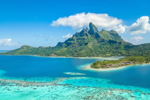 an aerial view of a tropical island in the ocean at The St. Regis Bora Bora Resort in Bora Bora