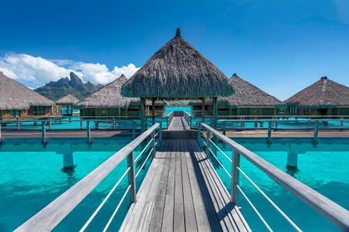 a bridge over the water in the maldives at The St. Regis Bora Bora Resort in Bora Bora