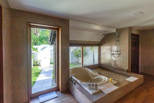 a large bathroom with a tub and a large window at The St. Regis Bora Bora Resort in Bora Bora