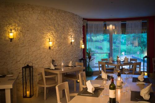 a restaurant with tables and chairs and a stone wall at The St. Regis Bora Bora Resort in Bora Bora
