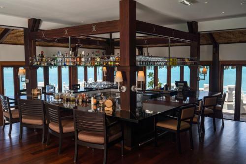 a bar in a restaurant with a view of the ocean at The St. Regis Bora Bora Resort in Bora Bora