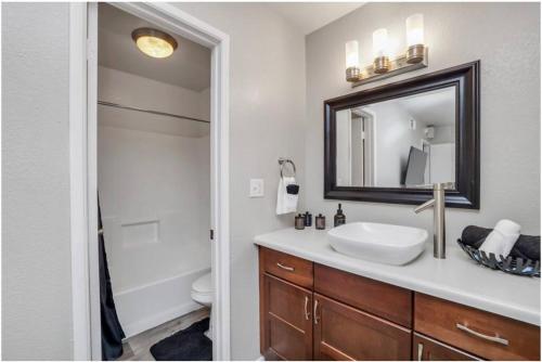 a bathroom with a sink and a mirror at Cozy 1BR sleep 6+ Free Parking in Phoenix