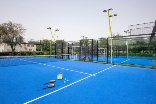 a tennis court with some tennis balls on it at Al Messila, A Luxury Collection Resort & Spa, Doha in Doha