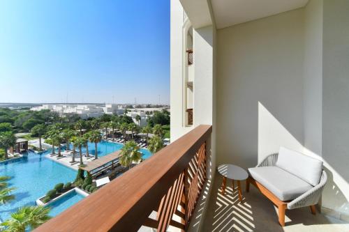 a balcony with a view of the pool at Al Messila, A Luxury Collection Resort & Spa, Doha in Doha