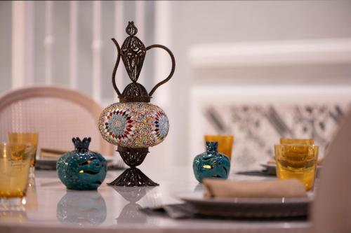 a table topped with vases on top of a table at Al Messila, A Luxury Collection Resort & Spa, Doha in Doha