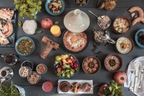 a table topped with plates of food and bowls of food at Al Messila, A Luxury Collection Resort & Spa, Doha in Doha