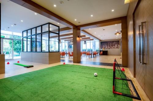 a living room with a soccer ball on a green carpet at Al Messila, A Luxury Collection Resort & Spa, Doha in Doha