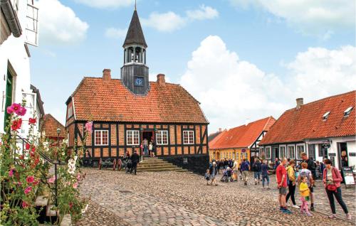 a group of people walking in front of a building at 3 Bedroom Cozy Apartment In Ebeltoft in Ebeltoft