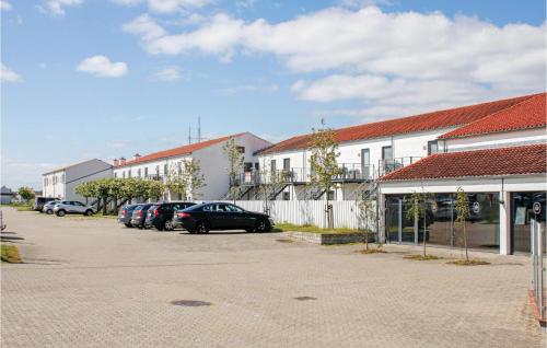 a parking lot with cars parked in front of buildings at 3 Bedroom Cozy Apartment In Ebeltoft in Ebeltoft