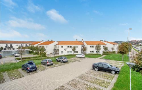 a group of cars parked in front of a building at 3 Bedroom Cozy Apartment In Ebeltoft in Ebeltoft