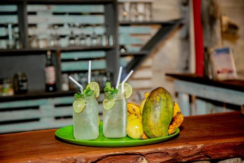 a plate of fruit and drinks on a table at Brother's Beach Home in Galle