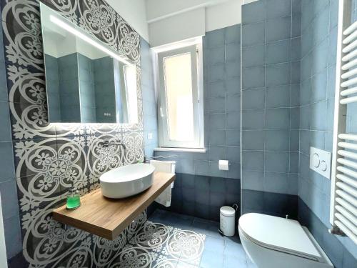 a bathroom with a sink and a toilet and a mirror at Il Giglio di Mare, la spiaggia a un passo da te in Pescara