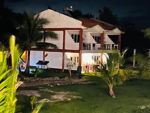 a house at night with the lights on at Cabilao Sunset Dive & Beach Resort in Loon