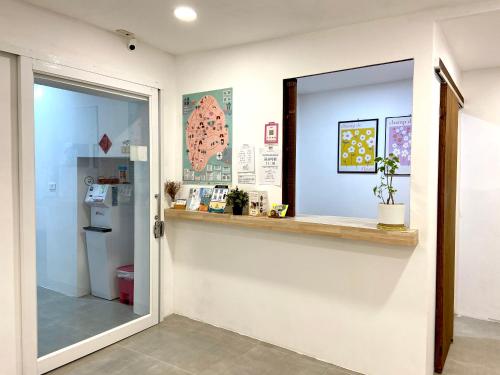 a room with a window and a counter and a refrigerator at 南鴻雅築South Home in Nanwan