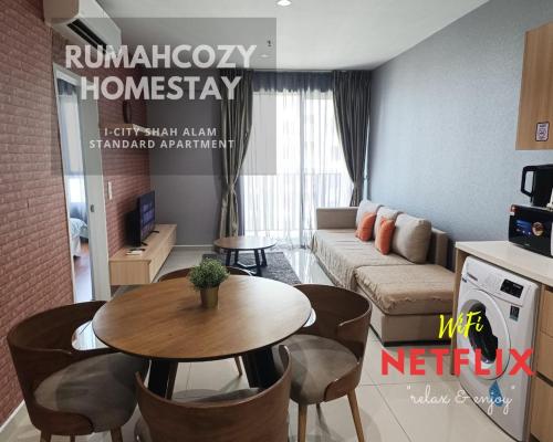 a living room with a couch and a table at RUMAHCOZY Homestay i-City Shah Alam in Shah Alam