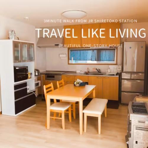 a kitchen with a table and chairs in a room at Okhotsk House Shari in Shari