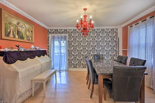 a dining room with a table and a chandelier at Charming New York Escape Near Central Park! in Jericho