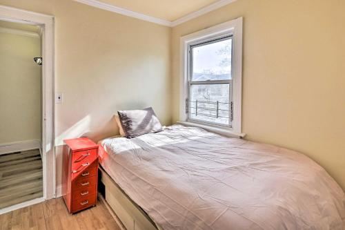 a small bedroom with a bed and a window at Charming New York Escape Near Central Park! in Jericho