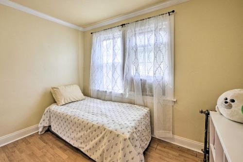 a small bedroom with a bed and a window at Charming New York Escape Near Central Park! in Jericho